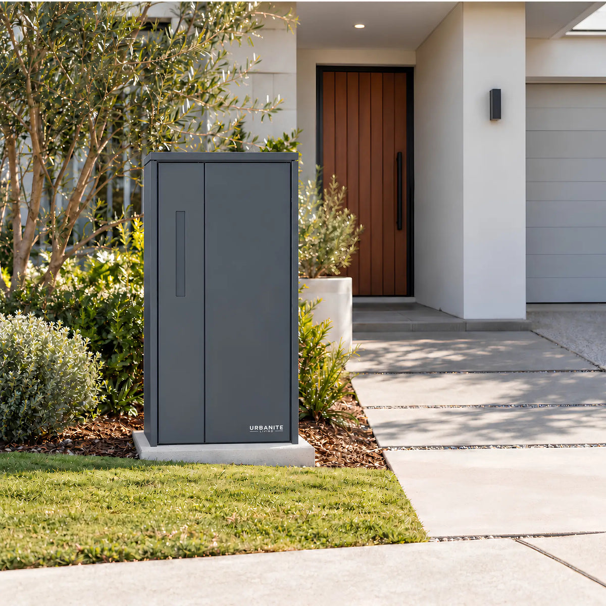 Urbanite Living The Don Extra Wide Parcel Letterbox in charcoal beside a landscaped front path. 