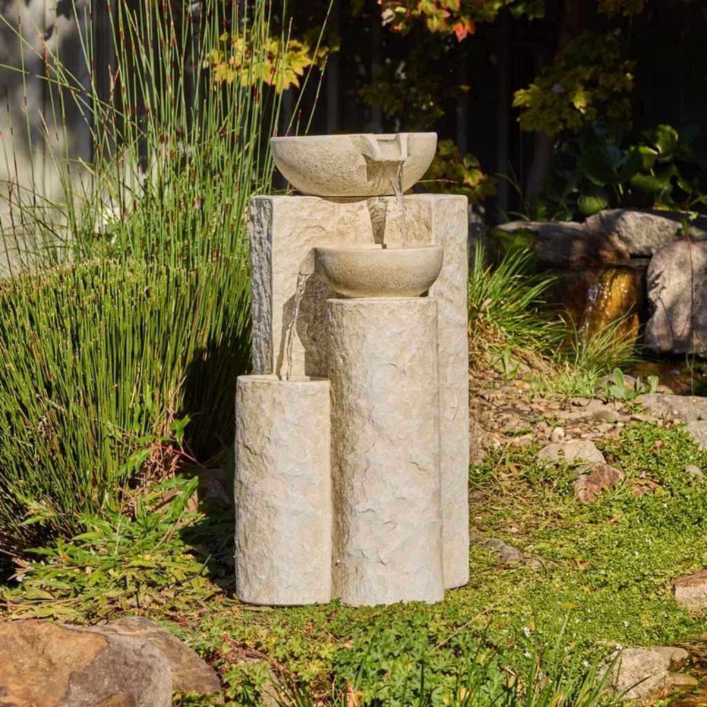 Echo Falls Fountain outside in a garden setting with native grass behind it.