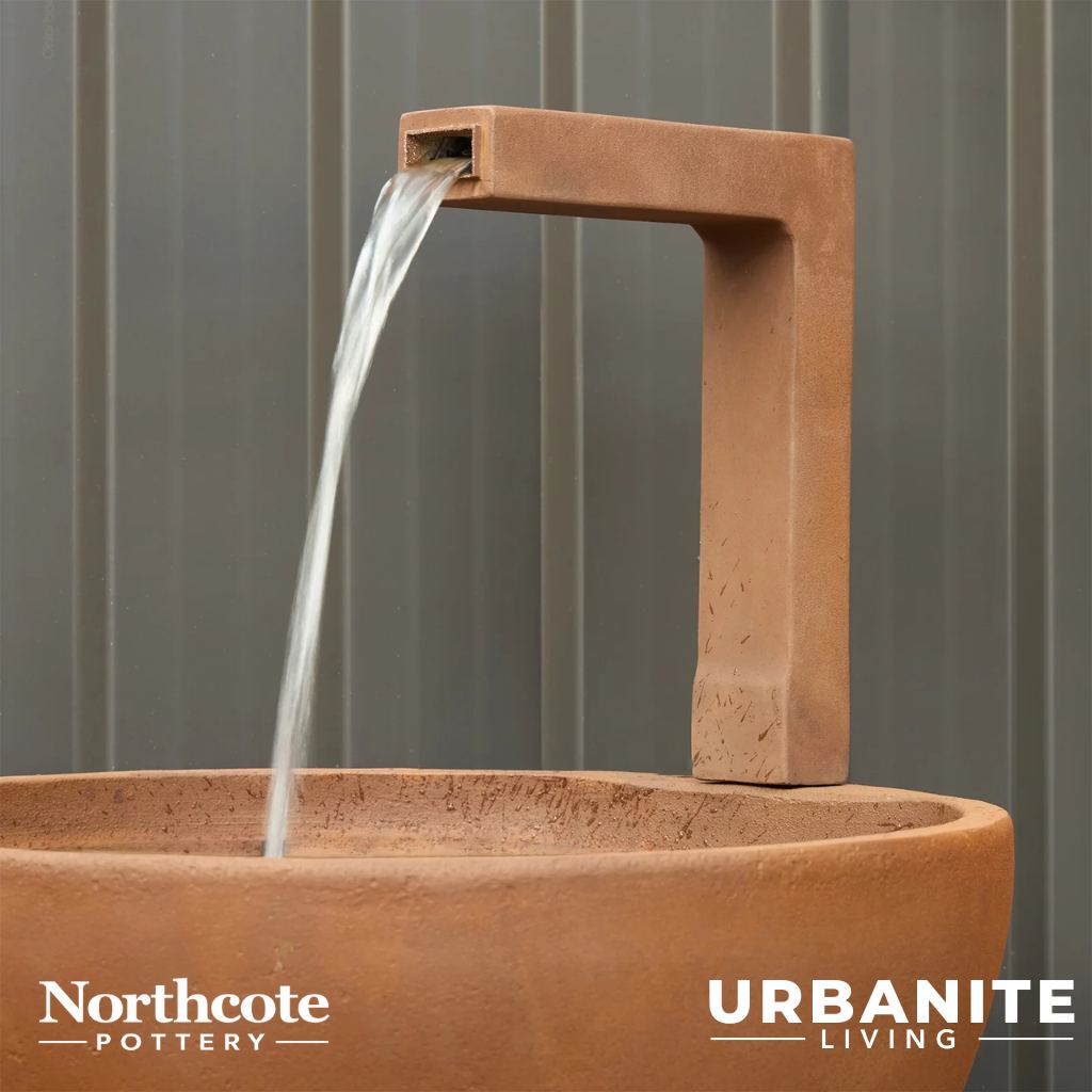 Close up of a black spout for the patio pond in the colour Iron Rust.