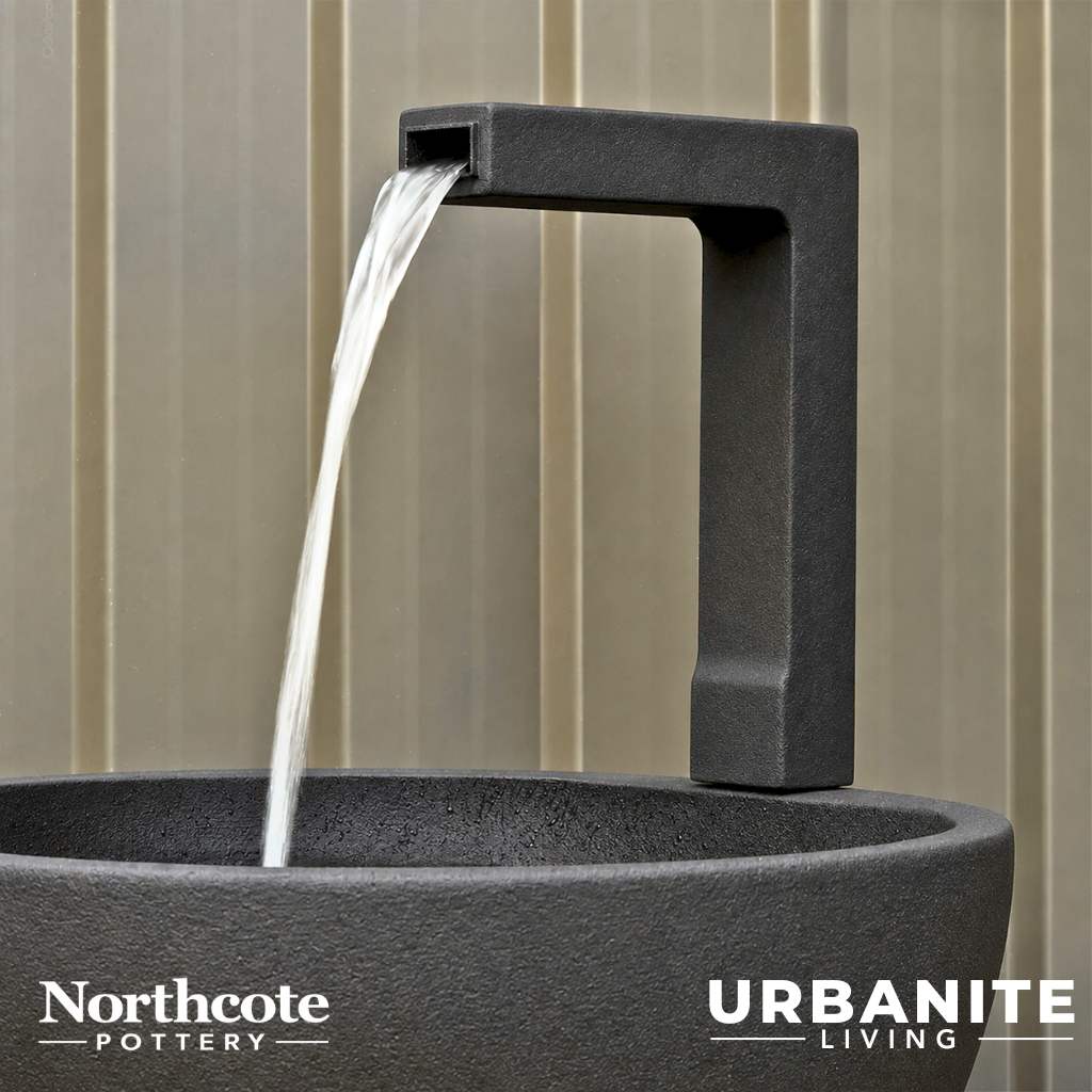 Close up of a black spout for the patio pond in black.
