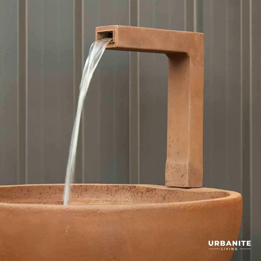 Close up of a black spout for the patio pond in the colour Iron Rust.